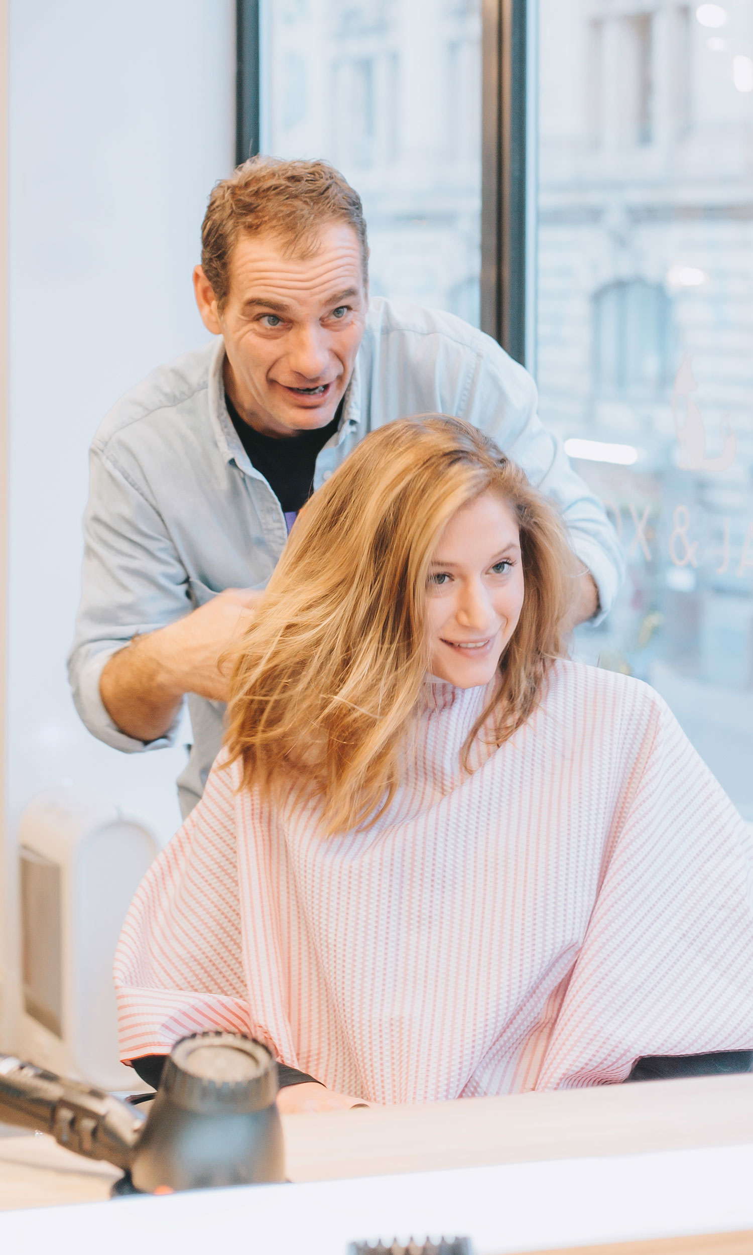 Hair stylists cut hair in salon